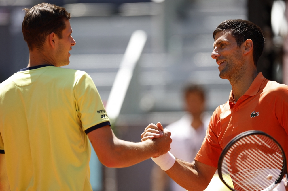 May 6, 2022 Serbia's Novak Djokovic shakes hands with Poland's Hubert Hurkacz after winning their quarter final match REUTERS/Juan Medina