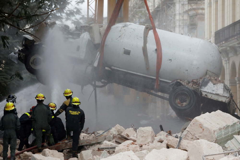 A gas tanker truck is lifted from debris after an explosion hit the Hotel Saratoga, in Havana, Cuba May 6, 2022. REUTERS