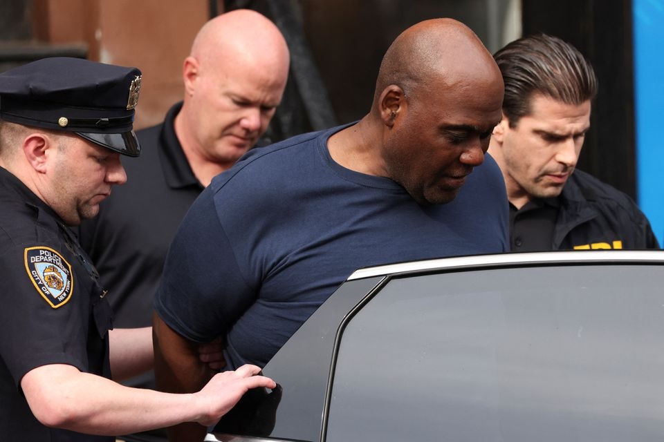 Frank James, the suspect in the Brooklyn subway shooting enters a car outside a police precinct in New York City, New York, U.S., April 13, 2022. REUTERS/Andrew Kelly

