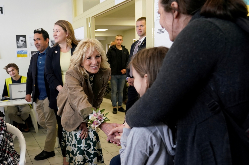 U.S. first lady Jill Biden greets a girl as she meets Ukrainian refugees and humanitarian workers at a city-run refugee center in Kosice, Slovakia, May 8, 2022. Susan Walsh/Pool via REUTERS
 