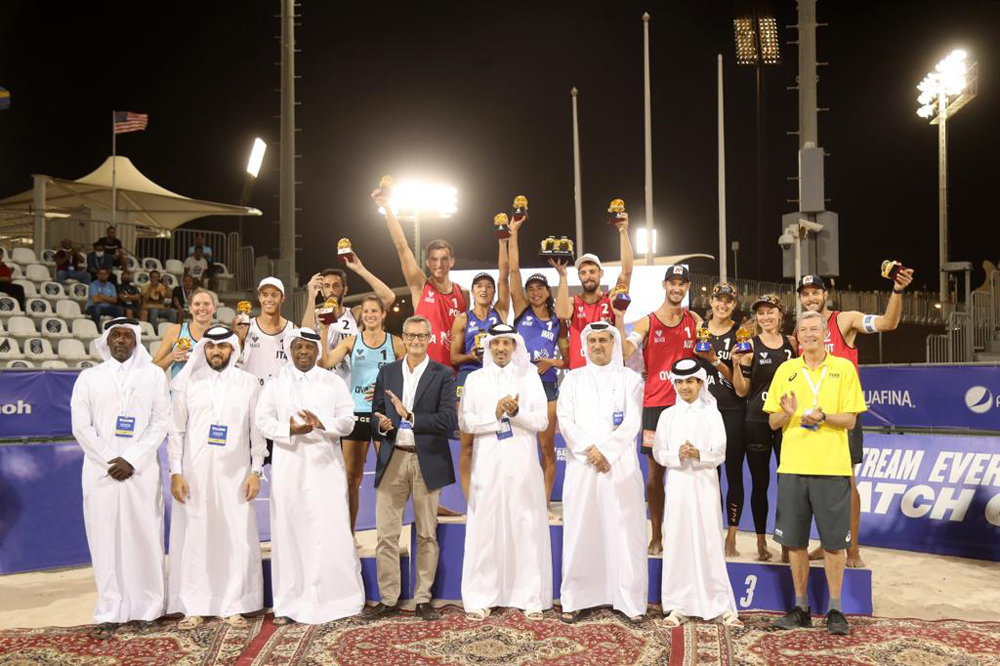 Qatar Volleyball Association President Ali Ghanim Al Kuwari and officials pose for a photograph with the men's and women's podium winners of the Volleyball World Beach Pro Tour Doha Challenge at the Al Gharafa Beach Courts yesterday.