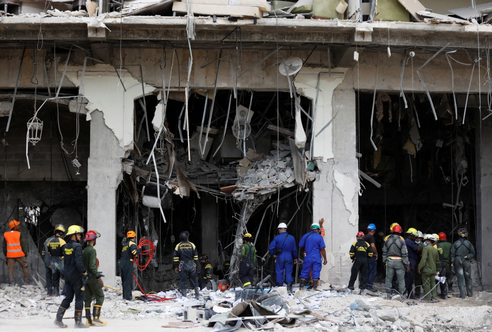 Emergency personnel work at the Saratoga Hotel two days after it suffered an explosion, in Havana, Cuba May 8, 2022. REUTERS/Alexandre Meneghini