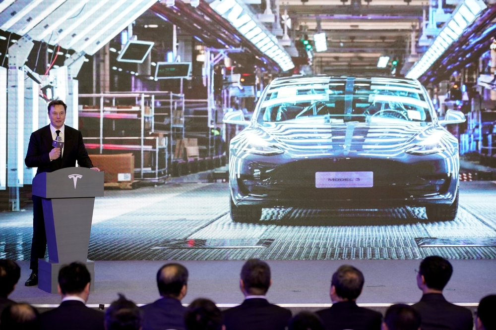Tesla Inc CEO Elon Musk speaks next to a screen showing an image of Tesla Model 3 car during an opening ceremony for Tesla China-made Model Y program in Shanghai, China January 7, 2020. REUTERS/Aly Song/File Photo
