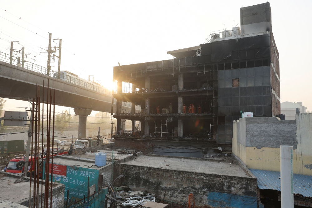 National Disaster Response Force (NDRF) and fire brigade personnel conduct a search and rescue operation after a fire broke out in a commercial building, in New Delhi, India, May 14, 2022. Reuters/Anushree Fadnavis