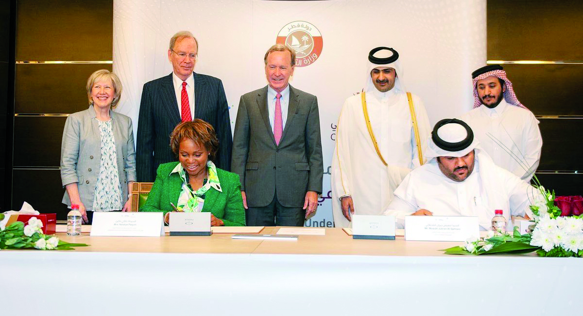 Minister of Culture H E Sheikh Abdulrahman bin Hamad bin Jassim bin Hamad Al Thani and other officials look on as the agreement is signed.