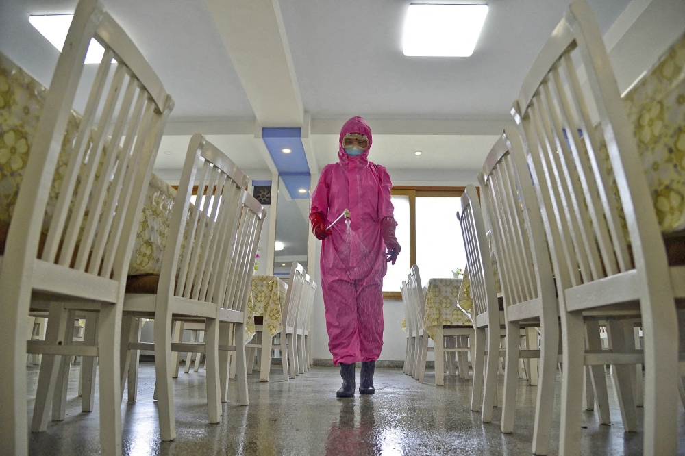 A worker disinfects a dining room at a sanitary supplies factory, amid growing fears over the spread of the coronavirus disease (COVID-19), in Pyongyang, North Korea, in this photo taken on May 16, 2022 and released by Kyodo on May 17, 2022. Mandatory credit Kyodo/via REUTERS