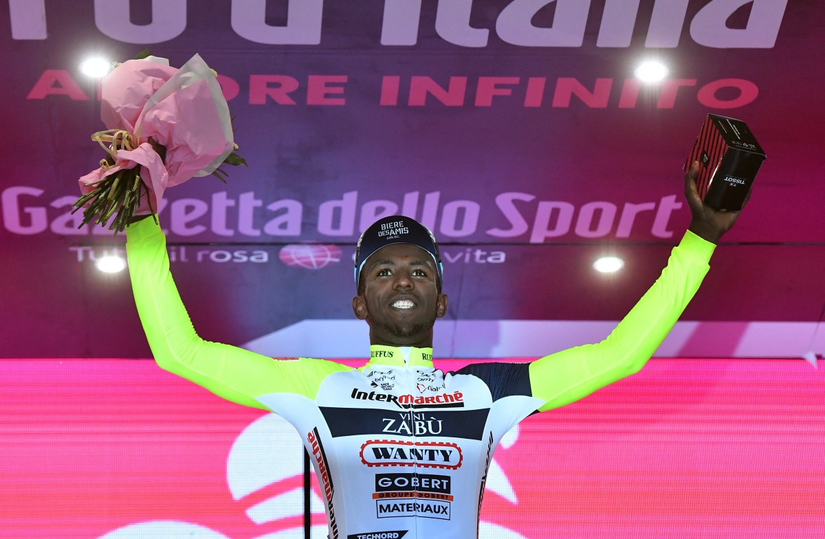 Gobert Materiaux's Biniam Girmay celebrates on the podium after winning stage 10 REUTERS/Jennifer Lorenzini
