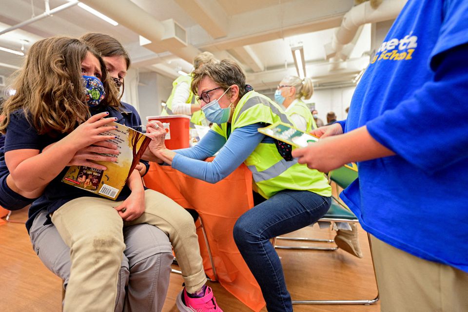 A child reacts while receiving a dose of the Pfizer-BioNTech coronavirus disease (COVID-19) vaccine at Smoketown Family Wellness Center in Louisville, Kentucky, U.S., November 8, 2021. REUTERS/Jon Cherry/


