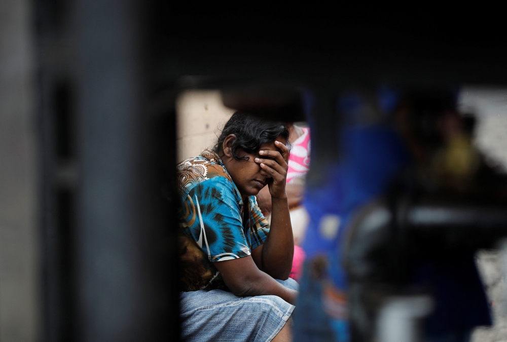A woman reacts as she waits in a queue to buy kerosene at a fuel station, amid the country's economic crisis in Colombo, Sri Lanka, May 18, 2022. REUTERS/Adnan Abidi