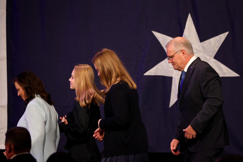 Incumbent Prime Minister Scott Morrison, leader of the Australian Liberal Party, leaves the stage with his wife Jenny and daughters Lily and Abbey, after addressing supporters and conceding defeat in the country's general election in Sydney, Australia, on May 21, 2022. (REUTERS/Loren Elliott)