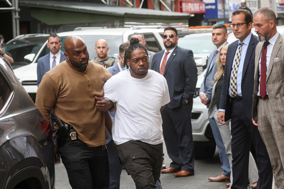 New York subway shooting suspect Andrew Abdullah is escorted by New York City Police (NYPD) Detectives in to a Police Precinct in New York City, U.S., May 24, 2022. REUTERS/Brendan McDermid
