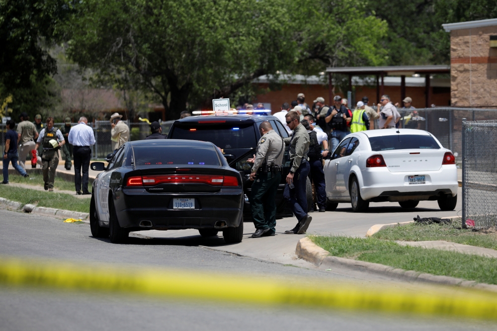 Law enforcement officers guard the scene of a shooting at Robb Elementary School in Uvalde, Texas, U.S. May 24, 2022. REUTERS/Marco Bello