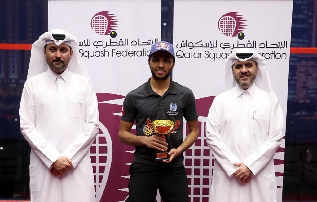 Abdulla Al Tamimi poses with the trophy along with Qatar Tennis, Squash, Badminton Federation Secretary General Tariq Zainal.