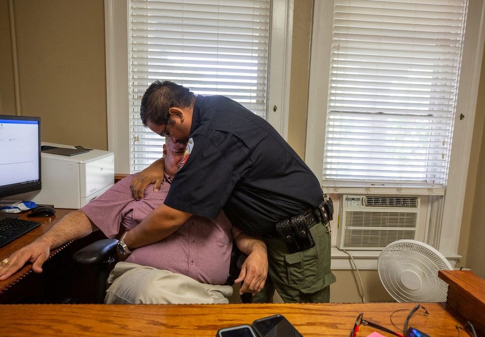 Constable David Valdez embraces Uvalde Justice of the Peace Eulalio Diaz as Diaz breaks down recounting having to identify the bodies of 19 children after they were shot by a gunman in Uvalde, Texas, U.S. May 25, 2022. Omar Ornelas/USA Today Network via REUTERS

