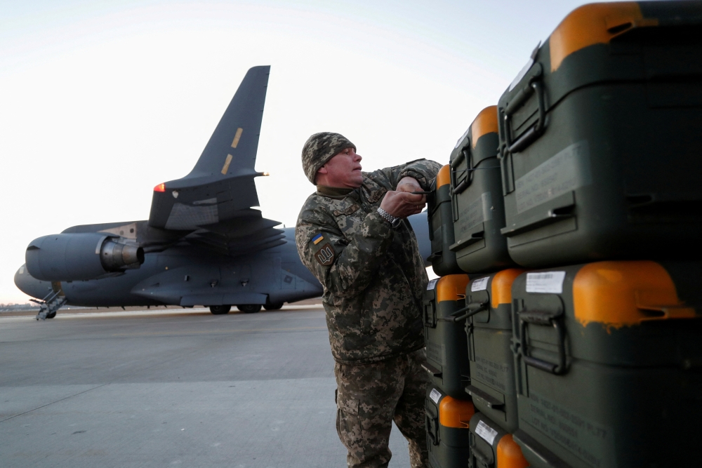 File photo: A Ukrainian service member unloads Lithuania's military aid including Stinger anti-aircraft missiles, delivered as part of the security support package for Ukraine by a 17 Globemaster III plane, at the Boryspil International Airport outside Kyiv, Ukraine, February 13, 2022. REUTERS