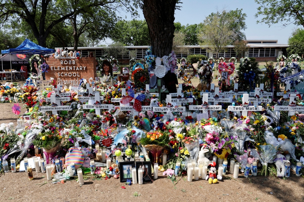 Tributes are seen at a memorial at Robb Elementary School, where a gunman killed 19 children and two teachers in the deadliest U.S. school shooting in nearly a decade, in Uvalde, Texas, U.S. May 29, 2022. REUTERS/Jonathan Ernst

