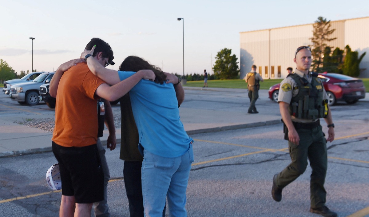 People pray at the CrossRoad Baptist Church parking lot after a shooting at Cornerstone Church in Ames, Iowa, U.S. June 2, 2022. Picture taken June 2, 2022. Nirmalendu Majumdar/USA Today Network via REUTERS. NO RESALES. NO ARCHIVES. MANDATORY CREDIT
