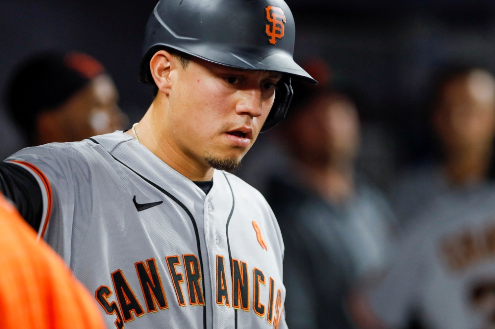 San Francisco Giants first baseman Wilmer Flores (41) celebrates in the dugout after scoring during the first inning against the Miami Marlins at loanDepot Park. Sam Navarro-USA TODAY Sports