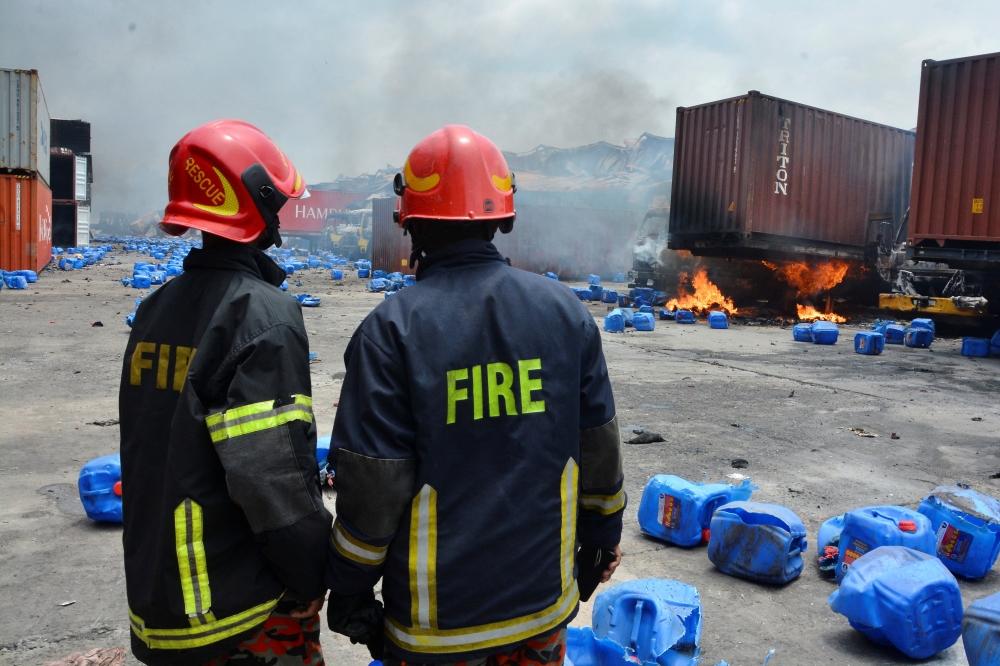 Firefighters work on the spot after a massive fire broke out in an inland container depot at Sitakund, near the port city Chittagong, Bangladesh, June 5, 2022. Reuters/Azim Aunon 