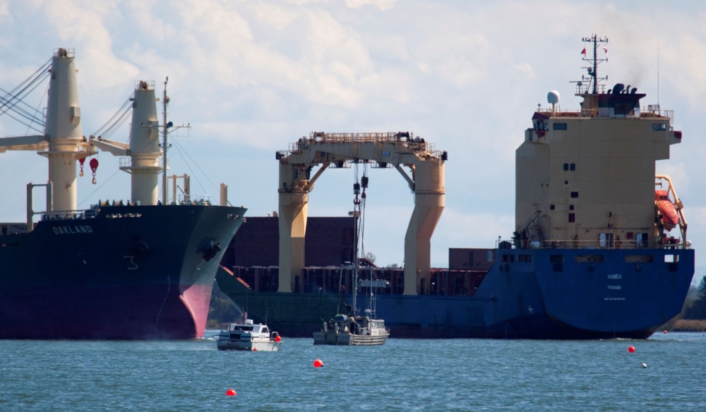 FILE PHOTO: Salmon fishing boats sit at the mouth of Fraser River as freighters move up and down the river in Steveston, British Columbia September 1, 2010. REUTERS/Andy Clark