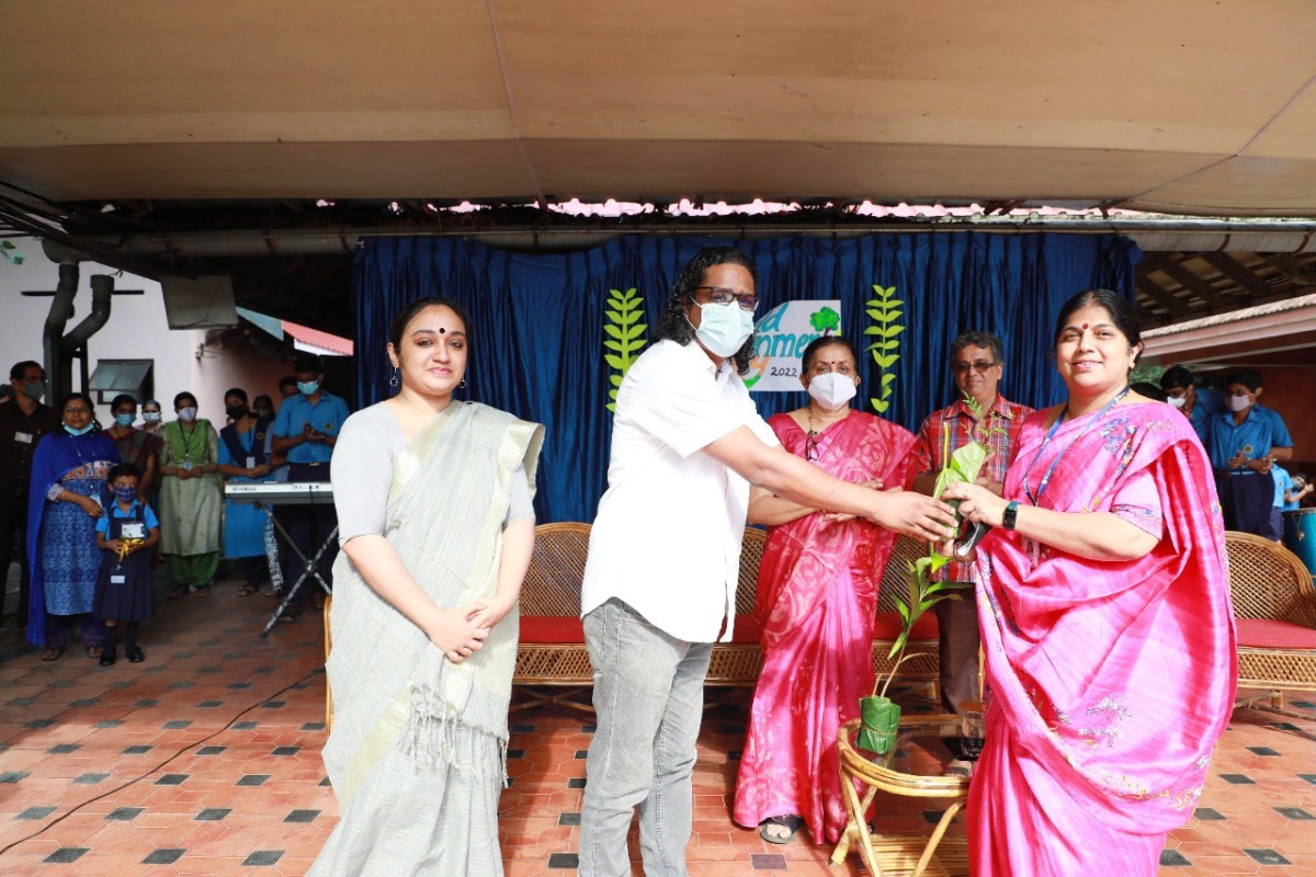 A sapling being handed over to mark the initiative.