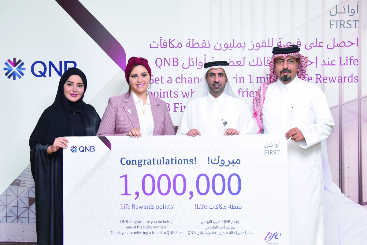 Final winner of the 1 Million Life Rewards points Sara Khalil, receives her prize from officials from QNB and MoCI, in Doha, recently.  