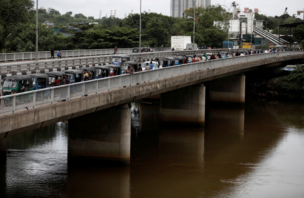 Three-wheeler drivers wait in a queue to buy petrol due to fuel shortage, amid the country's economic crisis, in Colombo, Sri Lanka, on June 17, 2022. Reuters