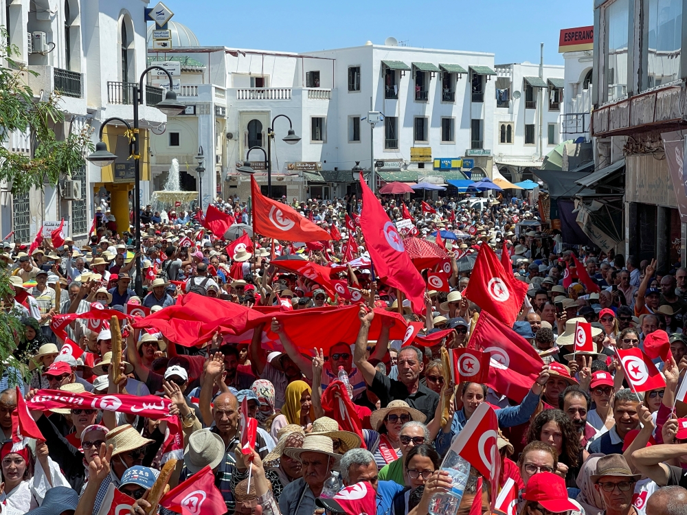 Demonstrators hold flags as they gather during a protest in opposition to a referendum on a new constitution called by President Kais Saied, in Tunis, Tunisia June 18, 2022. REUTERS/Jihed Abidellaoui