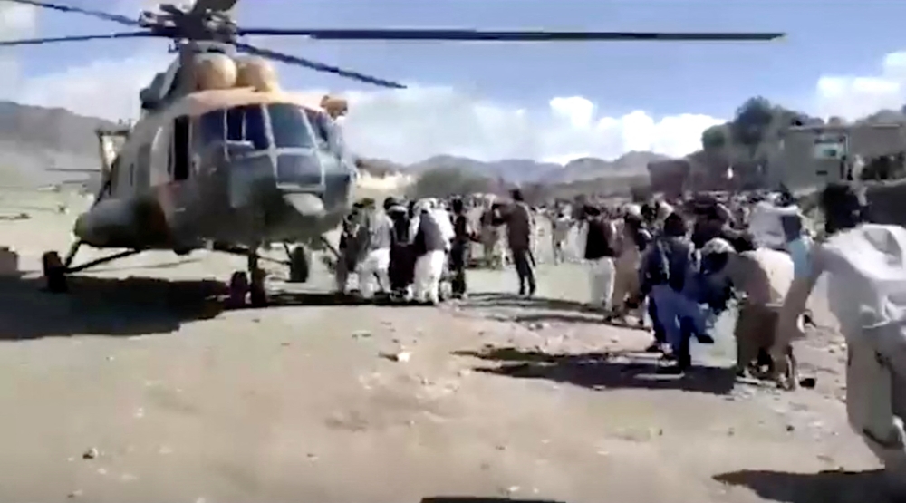People carry injured to a helicopter following a massive earthquake, in Paktika Province, Afghanistan, June 22, 2022, in this screen grab taken from a video. Bakhtar News Agency/Handout via Reuters