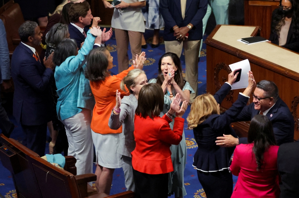 House of Representatives Democrats celebrate after passing of the 
