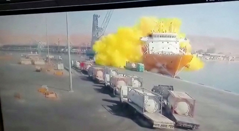 CCTV footage shows a storage tank containing chlorine gas crashing into a ship after falling from a winch, in Aqaba, Jordan June 27, 2022, in this still image taken from a handout video. Jordan TV/Handout via Reuters