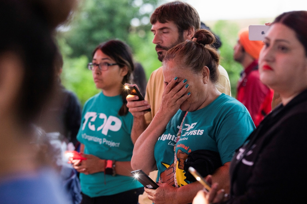 Maria Victoria de la Cruz reacts during a vigil for migrants who were found dead inside a trailer truck in San Antonio, Texas, U.S., June 28, 2022. Reuters/Kaylee Greenlee Beal