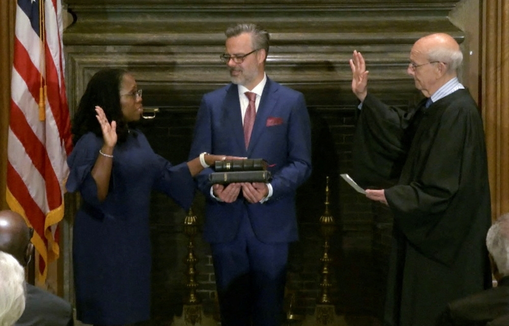 Judge Ketanji Brown Jackson takes her judicial oath of office as an Associate Justice of the US Supreme Court, as her husband Patrick Jackson holds the Bible in a framegrab from handout video provided by the Supreme Court, in Washington, US, on June 30, 2022. (Reuters)