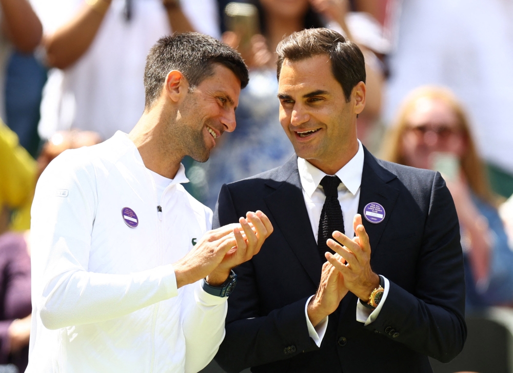 Serbia's Novak Djokovic (left) and Switzerland's Roger Federer during centre court centenary celebrations at the All England Lawn Tennis and Croquet Club, London, Britain, on July 3, 2022. (Reuters/Hannah Mckay)