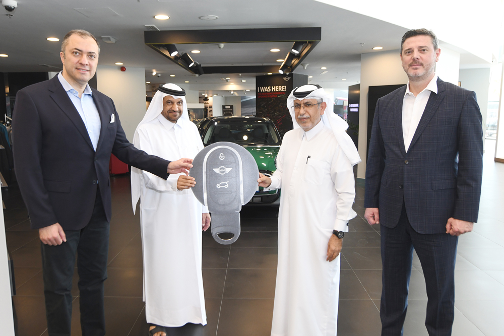 Deputy CEO of Dar Al Sharq Group Jaber Al Harami, with other officials, hands over the key of 2021 Mini Cooper to Mohamed Mubarak Al Shahwani, winner of the ‘Browse and Win’ campaign.  PIC: Amr Diab 