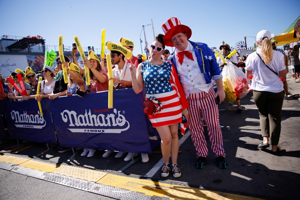 People attend the 2022 Nathan’s Famous Fourth of July International Hot Dog Eating Contest as it returns to the iconic Nathan’s Famous flagship restaurant after the easing of COVID-19 restrictions, at Coney Island in New York, US, July 4, 2022. (Reuters/Eduardo Munoz)