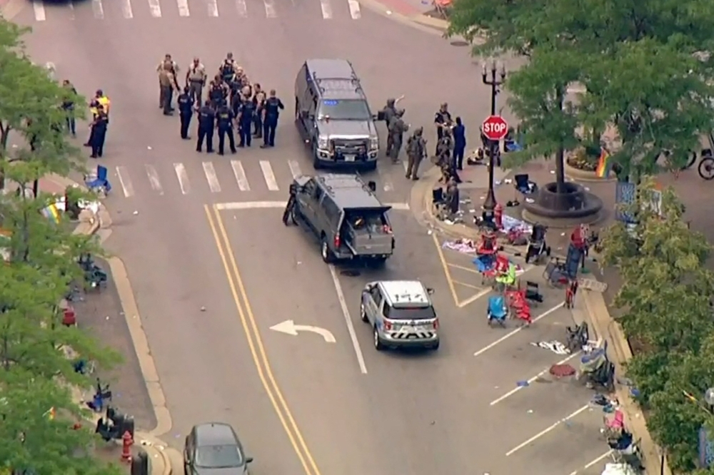 Police deploy after gunfire erupted at a Fourth of July parade route in the wealthy Chicago suburb of Highland Park, Illinois, US, on July 4, 2022 in a still image from video. (Reuters)