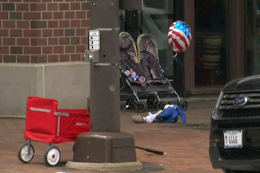 A child's stroller with a stars and stripes balloon attached is left after gunfire erupted at a Fourth of July parade route in the wealthy Chicago suburb of Highland Park, Illinois, US, on July 4, 2022 in a still image from video. (Reuters)