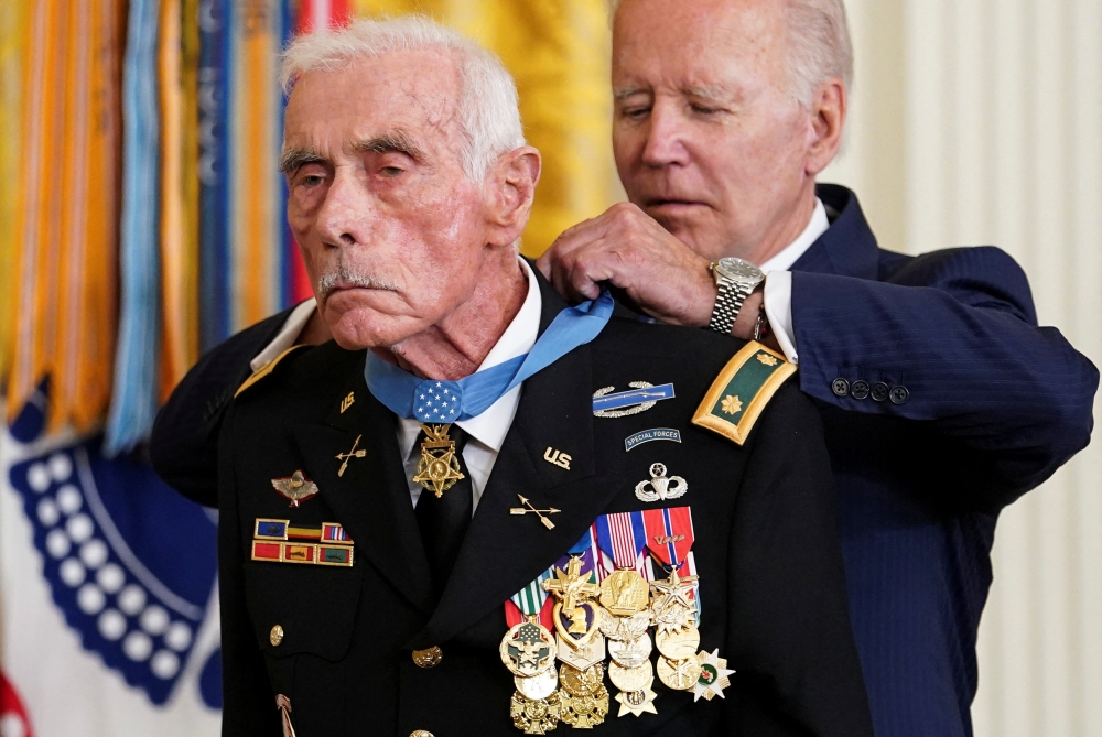 US President Joe Biden awards the Medal of Honor to US Army veteran retired Major John Duffy, who fought in the Vietnam War, during a ceremony in the East Room at the White House in Washington, US, July 5, 2022. (Reuters/Kevin Lamarque)
