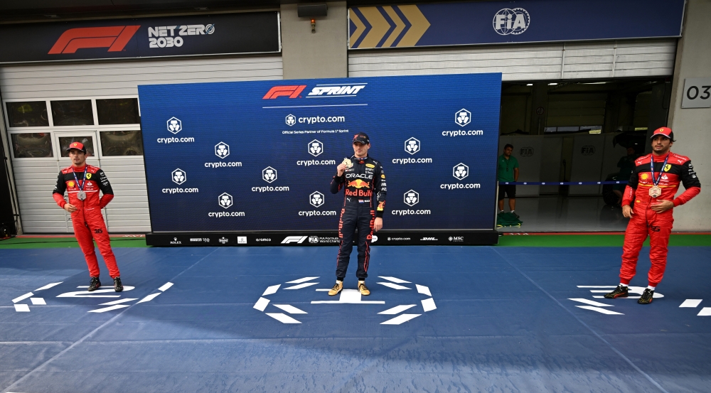 Red Bull's Max Verstappen celebrates after winning the sprint race as Ferrari's Charles Leclerc celebrates after placing second and Carlos Sainz Jr. celebrates after placing third. (REUTERS/Christian Bruna)