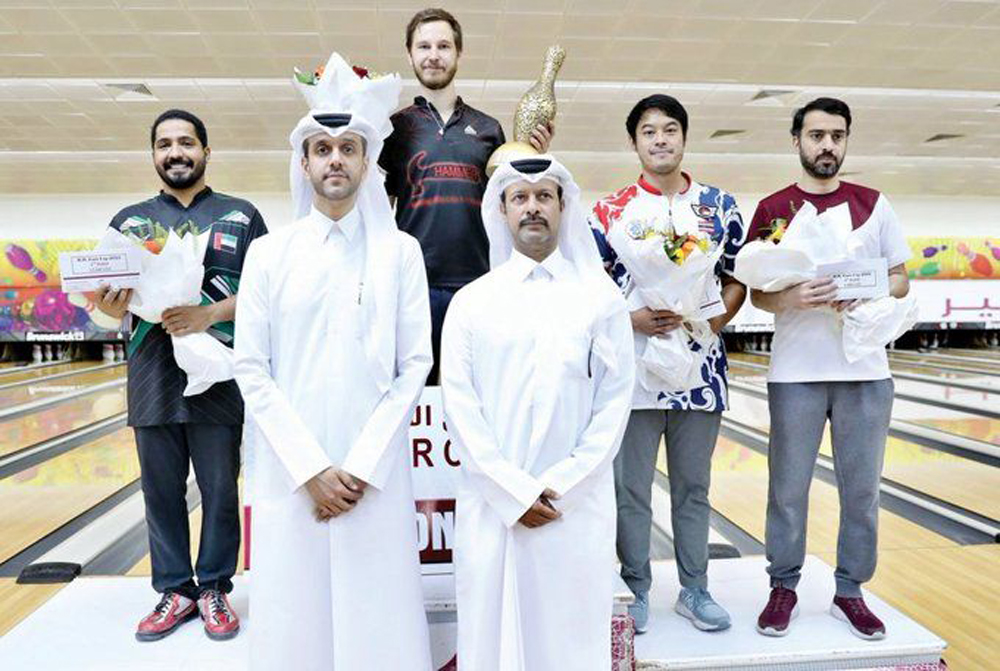 The podium winners of the H H The Amir’s Cup Bowling Championship with officials during the presentation ceremony.