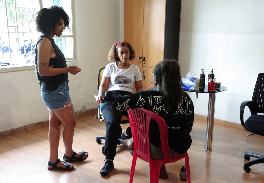 Tsigereda Birhanu (L), a 27-year-old advocate for migrant workers in Lebanon, speaks with her friends, in Beirut, Lebanon July 5, 2022. REUTERS/Mohamed Azakir