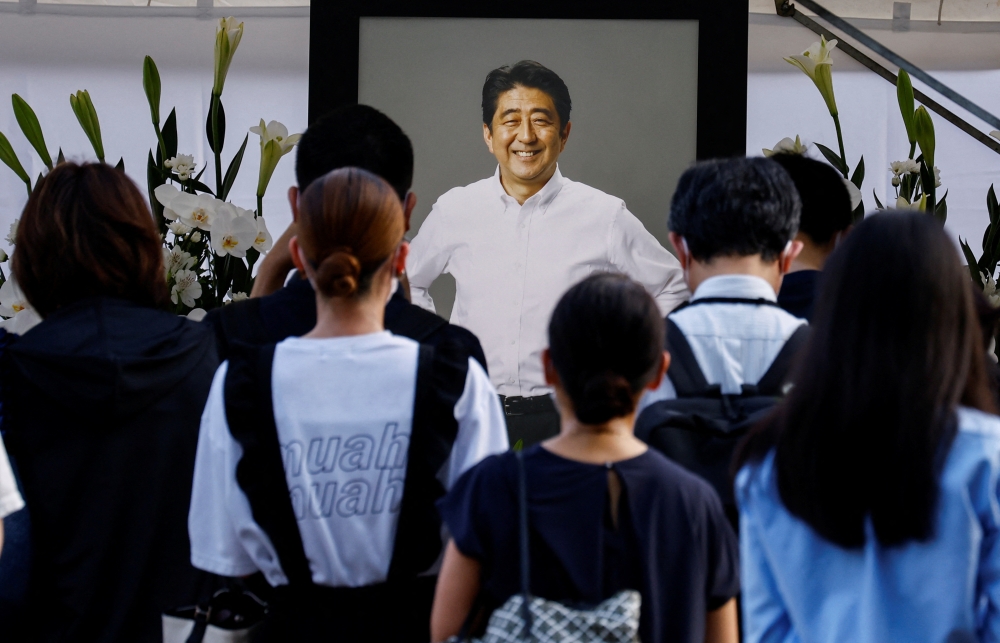 People lay flowers at Zojoji Temple where the vigil and funeral of late former Japanese Prime Minister Shinzo Abe takes place, in Tokyo, Japan, July 11, 2022. (REUTERS/Kim Kyung-Hoon)

