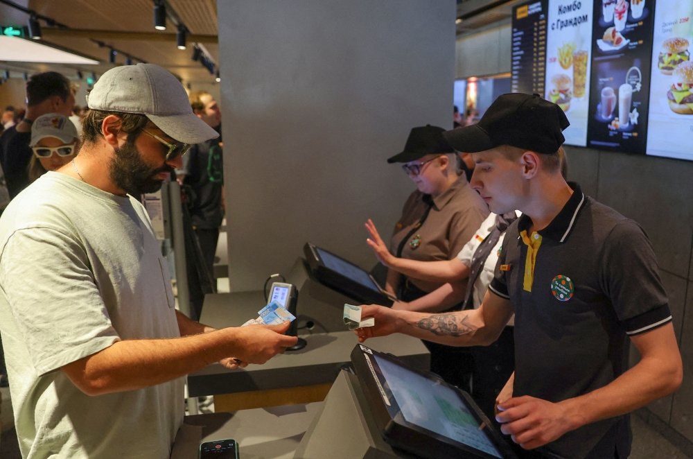 A customer pays for a meal at the new restaurant 