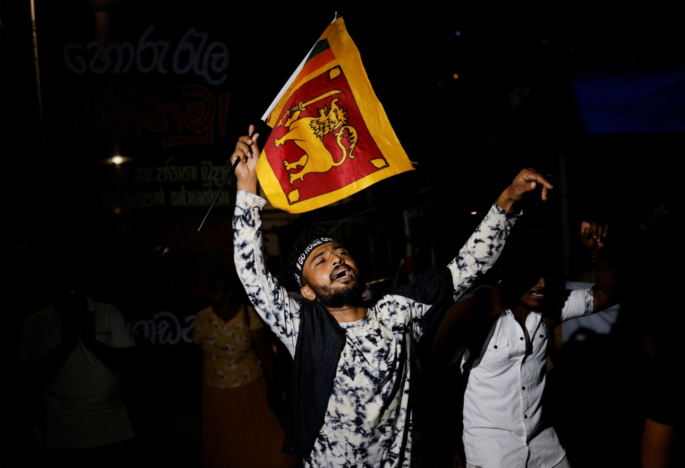 People celebrate the resignation of Sri lanka’s President Gotabaya Rajapaksa at a protest site, amid the country’s economic crisis, in Colombo, Sri Lanka, July 14, 2022. (REUTERS/Adnan Abidi)

