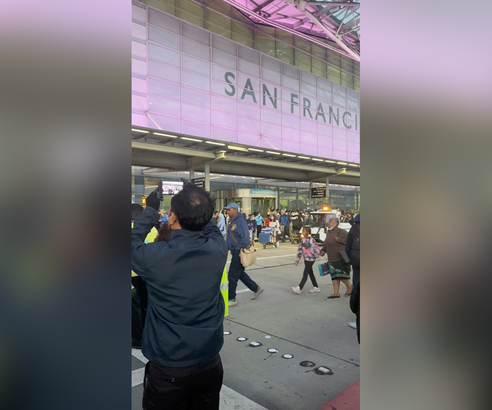 Travellers and airport staff are evacuated from San Francisco International airport, after police found a suspicious object at the airport following a bomb threat, in San Francisco, California, U.S. July 15, 2022 in this screen grab obtained from social media video. Malena Leon-Farrera/via REUTERS