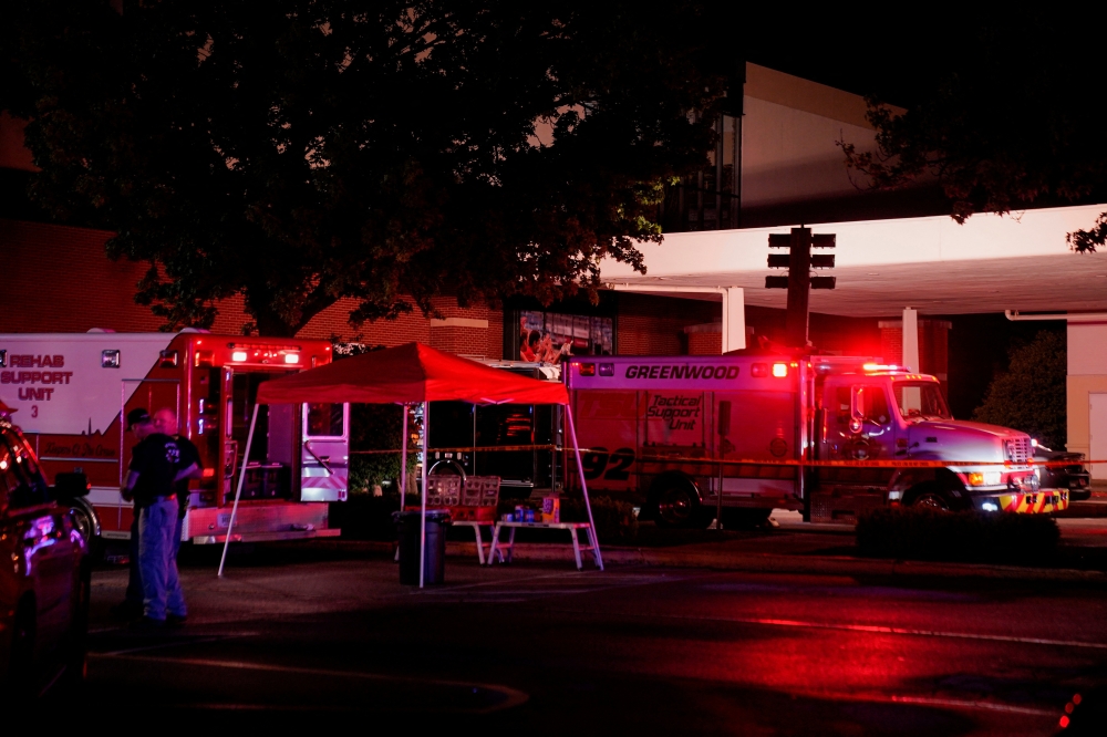 Law enforcement officers stand guard near the crime scene after a shooting at a mall in the Indianapolis suburb of Greenwood, Indiana, U.S. July 17, 2022. REUTERS/Cheney Orr