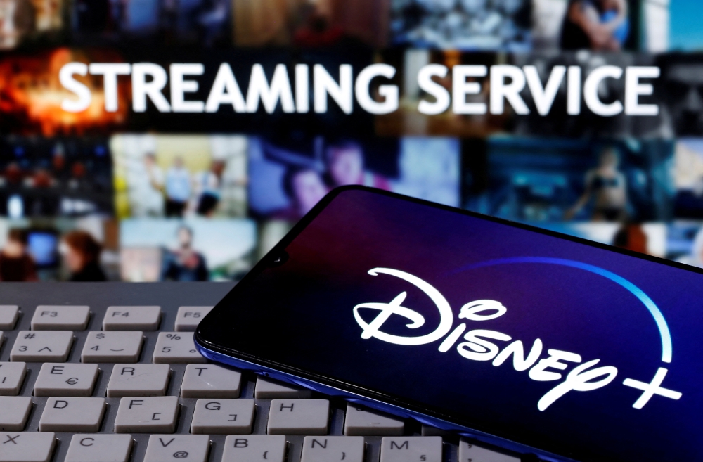 File Photo: A smartphone with the Disney logo is seen on a keyboard in front of the words 'Streaming service' in this picture illustration taken March 24, 2020. (REUTERS/Dado Ruvic)

