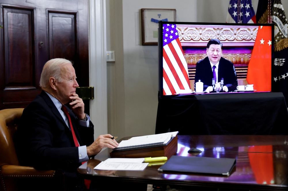 FILE PHOTO: U.S. President Joe Biden speaks virtually with Chinese leader Xi Jinping from the White House in Washington, U.S. November 15, 2021. REUTERS/Jonathan Ernst/File Photo