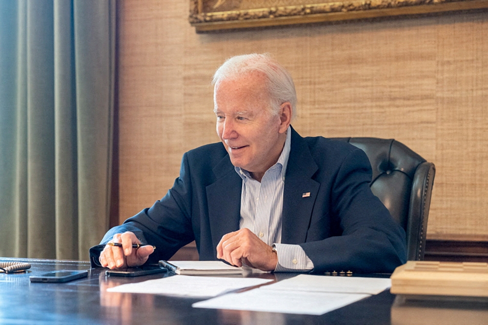 U.S. President Joe Biden, who tested positive for COVID-19 while experiencing mild symptoms, sits at his desk in the White House residence in this handout photo obtained from President Biden's Twitter account on July 21, 2022. Courtesy Twitter President Biden@POTUS/Handout via REUTERS
